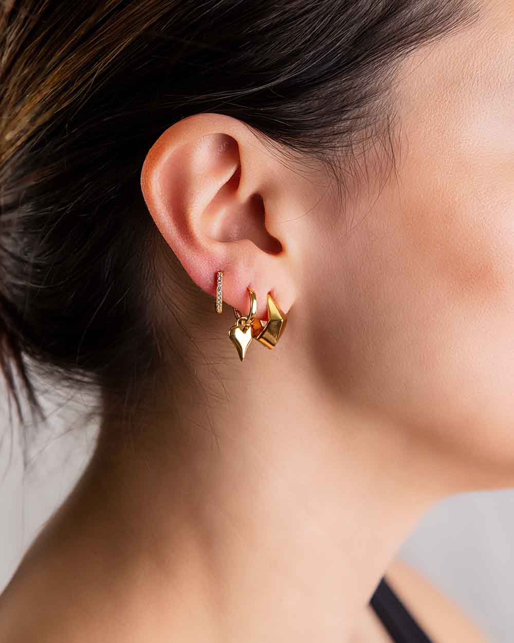 A women wears stacks of earrings