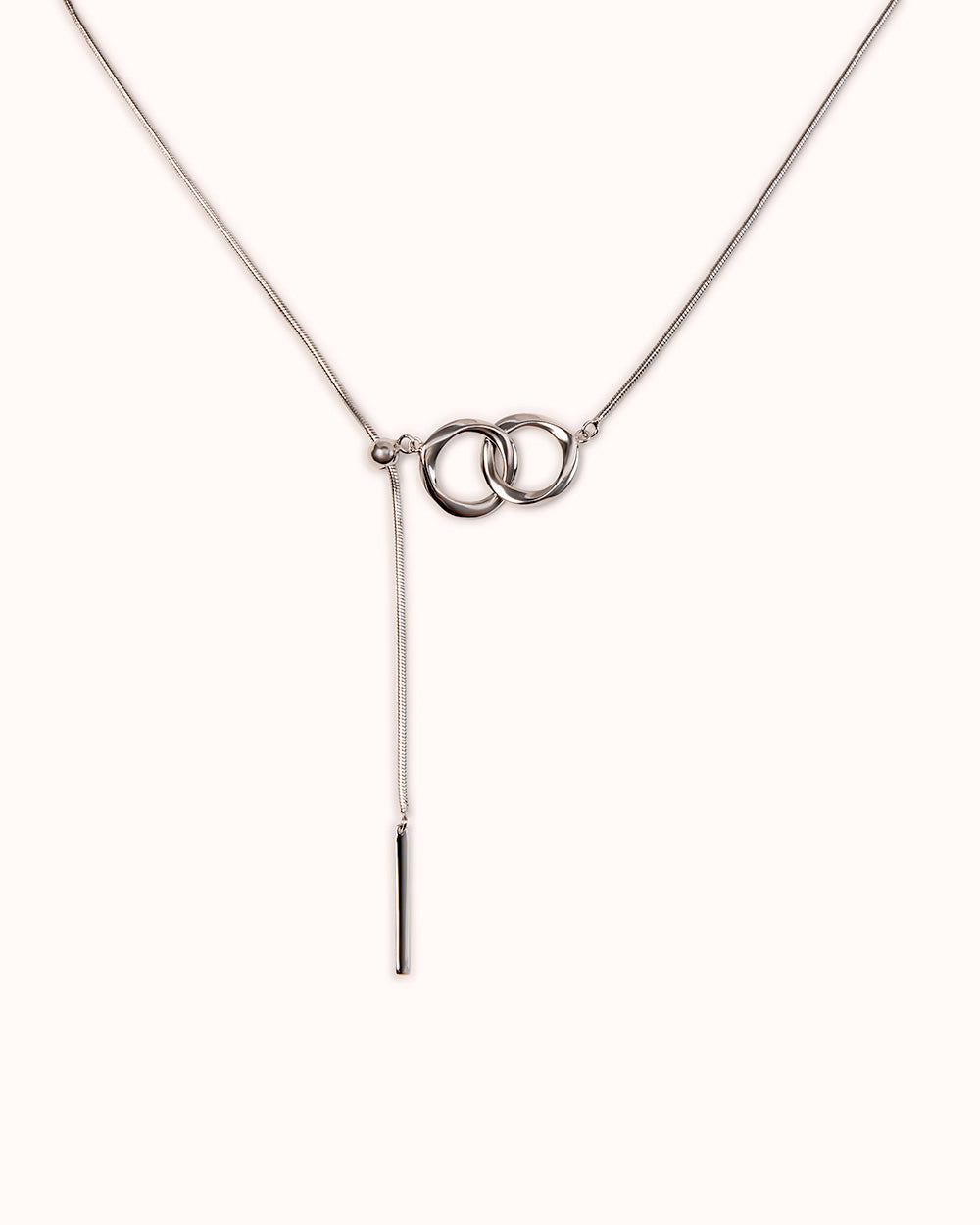 A sleek sterling silver slider necklace featuring interlinked rings and a skinny stick pendant, perfect for versatile styling.