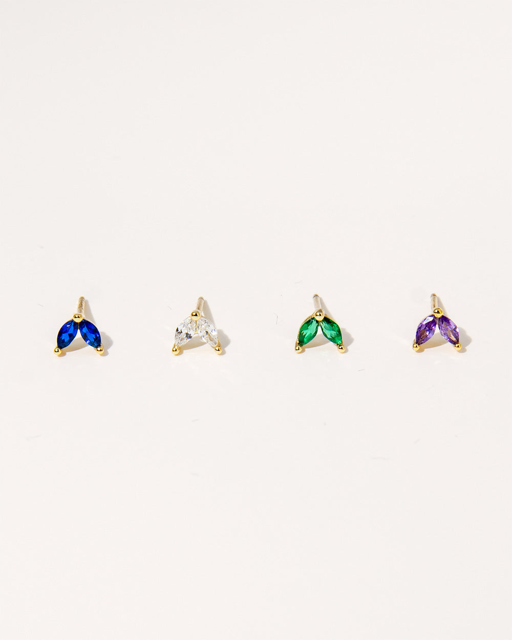 Prism Pop Studs: Vibrant Cubic Zirconia gemstones in blue, white, green, or purple set in sterling silver, adding a colorful sparkle to your look